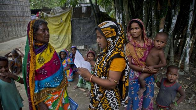 A Muslim woman checks for names in the final list of the National Register of Citizens (NRC) on a printed sheet of paper in Pabhokati village in Morigaon district, in the northeastern Indian state of Assam. (AP) A Muslim woman checks for names in the final list of the National Register of Citizens (NRC) on a printed sheet of paper in Pabhokati village in Morigaon district, in the northeastern Indian state of Assam. (AP)