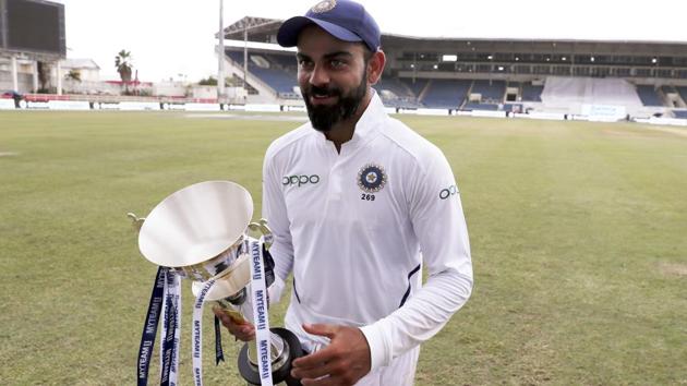 India's captain Virat Kohli walks with the series trophy. (AP)