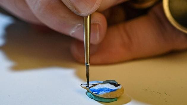 The 60-year-old artist, who has never had a formal art teacher, began researching miniature art in the 1980s. He was stunned, he said, by how tiny details and touches can change a form of artistic expression. But it was not until 1995 that he had the idea of doing it himself on unconventional objects. (Ozan Kose / AFP)