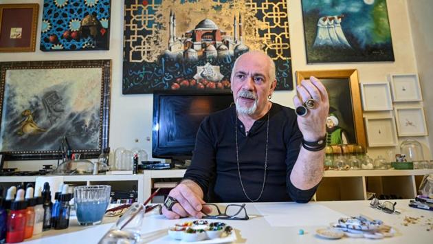 “While walking in the street, I come up with an idea and I sit down and work. All I need is a drop of water in a bottle cap and I take out my palette and paints.” Kale, who also designs jewellery, said he likes the way people recall his work. “They remember me when they eat popcorn at the movies or drink a cup of coffee or swim in the sea,” he said. (Ozan Kose / AFP)