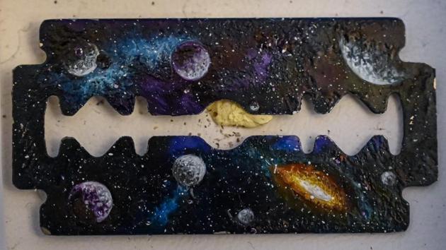 A landscape painted on a razor blade by Turkey’s micro artist Hasan Kale in Istanbul. His canvas could be anything from match sticks, seeds to razors and crown corks. Turkey’s micro artist, also known as Turkish Microangelo in reference to Italian Renaissance sculptor and painter Michelangelo, has been hitting his brush onto tiny everyday objects for more than two decades. (Ozan Kose / AFP)