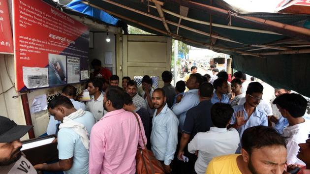 Taxi drivers stand in queue to receive Radio-frequency identification (RFID) tag, at NH-24, Ghazipur, in New Delhi, on Friday, August 16, 2019.(Sonu Mehta/HT PHOTO)