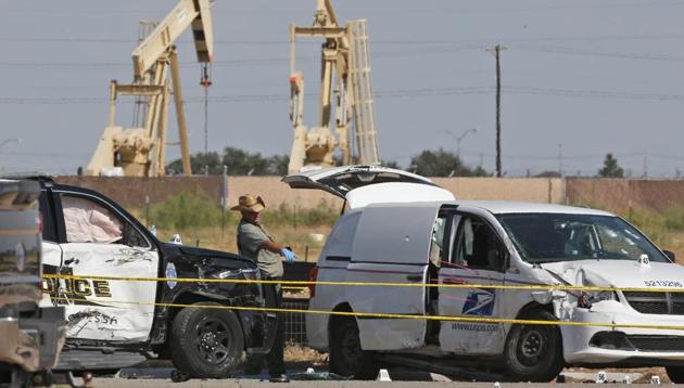 FILE - In this Sunday, Sept. 1, 2019, file photo, law enforcement officials process the crime scene from Saturday's shooting which ended with the shooter, Seth Ator, being shot dead by police in a stolen mail van, right, in Odessa, Texas. (AP Photo) FILE - In this Sunday, Sept. 1, 2019, file photo, law enforcement officials process the crime scene from Saturday's shooting which ended with the shooter, Seth Ator, being shot dead by police in a stolen mail van, right, in Odessa, Texas. (AP Photo)