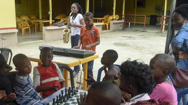 Young saxophonist Temilayo Abodurin (L) and pianist Joshua Akinotan play to motivate fellow children during a chess class. Ten-year-old Odunayo Olukoya joined Chess in Slums in January. Four months later, she came first in the national chess championship for her age group. (Pius Utomi Ekpei/ AFP) Young saxophonist Temilayo Abodurin (L) and pianist Joshua Akinotan play to motivate fellow children during a chess class. Ten-year-old Odunayo Olukoya joined Chess in Slums in January. Four months later, she came first in the national chess championship for her age group. (Pius Utomi Ekpei/ AFP)