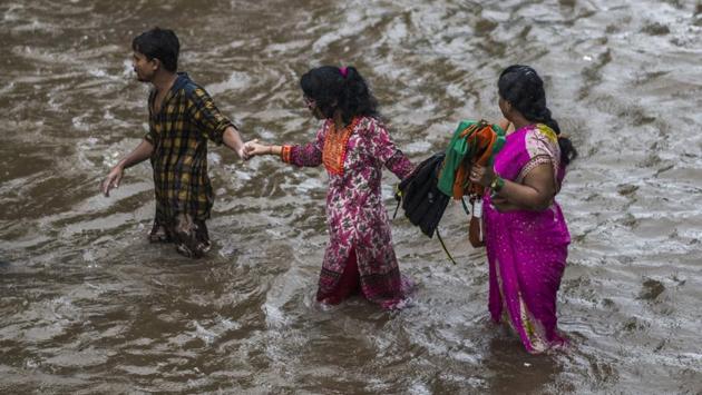 People wade through flooded street at Dadar TT circle in Mumbai. As many as 77 civic buses reported breakdowns of which 40 were affected due to rains, said a spokesperson of the transport undertaking BEST (Brihanmumbai Electric Supply and Transport). (Pratik Chorge / HT Photo) People wade through flooded street at Dadar TT circle in Mumbai. As many as 77 civic buses reported breakdowns of which 40 were affected due to rains, said a spokesperson of the transport undertaking BEST (Brihanmumbai Electric Supply and Transport). (Pratik Chorge / HT Photo)