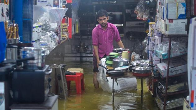 A shopkeeper bear knee deep water inside a shop at Andheri in Mumbai. The weather forecasting agency has predicted that the maximum and minimum temperature is most likely to remain around 25 degrees Celcius and 23 degrees Celcius, respectively. (Ragul Krishnan / HT Photo) A shopkeeper bear knee deep water inside a shop at Andheri in Mumbai. The weather forecasting agency has predicted that the maximum and minimum temperature is most likely to remain around 25 degrees Celcius and 23 degrees Celcius, respectively. (Ragul Krishnan / HT Photo)