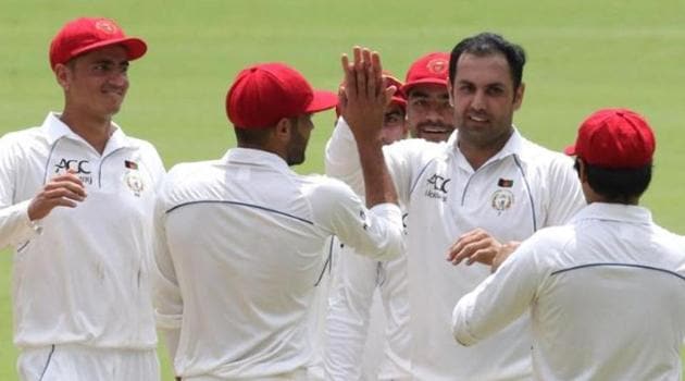 Mohammad Nabi celebrates with his teammates after the fall of a wicket.(ICC/ Twitter)