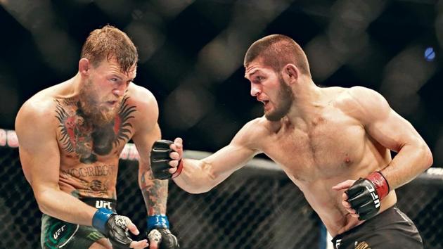 Khabib Nurmagomedov (R) defeated Conor McGregor in the UFC Lightweight title fight in October 2018 but a ringside brawl resulted in his suspension. Khabib will return to the cage for his second title defense against American Dustin Poirier on Saturday(getty images)