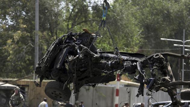 Resolute Support (RS) forces remove a destroyed vehicle after a car bomb explosion in Kabul, Afghanistan, Thursday, Sept. 5, 2019. The Afghan government says at least 10 civilians are dead and another 42 wounded after a Taliban suicide car bombing rocked the Afghan capital near a neighborhood housing the U.S. Embassy and the NATO Resolute Support mission. (AP Photo/Rahmat Gul)(AP)