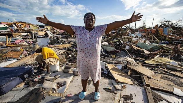 Aliana Alexis, of Haiti, stands on the concrete slab of what is left of her home after destruction from Hurricane Dorian in an area called “The Mud” at Marsh Harbour in Great Abaco Island, Bahamas. (Al Diaz / Miami Herald via AP) 