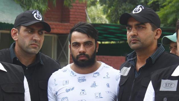 The Special Task Force (STF) Haryana police with gangster Kaushal who was arrested from Indira Gandhi International Airport early morning, at Police Commissioner Office in Faridabad. (Yogendra Kumar/HT PHOTO) The Special Task Force (STF) Haryana police with gangster Kaushal who was arrested from Indira Gandhi International Airport early morning, at Police Commissioner Office in Faridabad. (Yogendra Kumar/HT PHOTO)