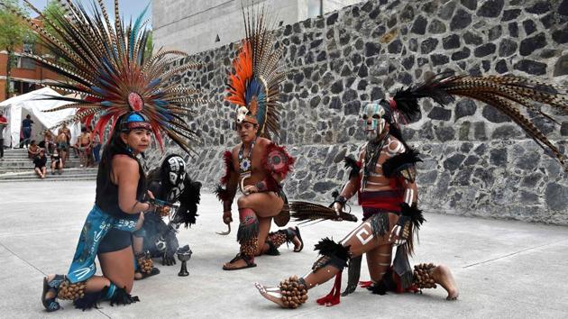 Dancers perform ahead of a game of Ulama at the FARO Poniente cultural center in Mexico City. This is the first time in half a millennium that there has been a place in Mexico City to play the game known in Spanish as ‘juego de pelota.’ Emmanuel Kakalotl, who coaches players at the cultural center where the new ulama court was built said, “The game had been forgotten... It was toppled 500 years ago, but now we’re raising it up again.” (Rocio Vazquez / AFP) Dancers perform ahead of a game of Ulama at the FARO Poniente cultural center in Mexico City. This is the first time in half a millennium that there has been a place in Mexico City to play the game known in Spanish as ‘juego de pelota.’ Emmanuel Kakalotl, who coaches players at the cultural center where the new ulama court was built said, “The game had been forgotten... It was toppled 500 years ago, but now we’re raising it up again.” (Rocio Vazquez / AFP)