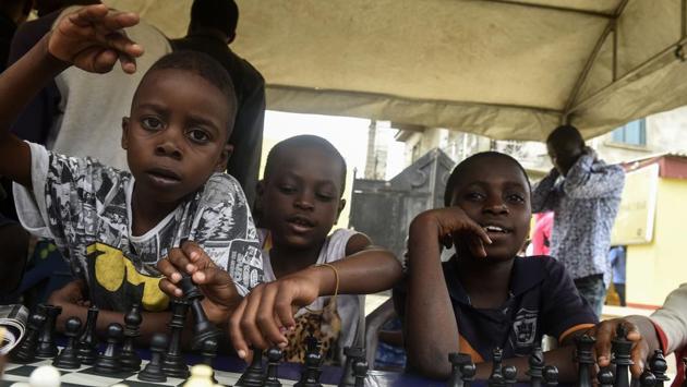 Children sit under a canopy as they play during a chess class. The attention that the project has generated has helped shine a spotlight on more of these marginalised children. Videos of the budding chess masters shared on Instagram also showcase some of their other talents that have often been overlooked in the struggle to survive. (Pius Utomi Ekpei/ AFP) Children sit under a canopy as they play during a chess class. The attention that the project has generated has helped shine a spotlight on more of these marginalised children. Videos of the budding chess masters shared on Instagram also showcase some of their other talents that have often been overlooked in the struggle to survive. (Pius Utomi Ekpei/ AFP)