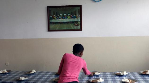 A girl sets a table below a painting depicting “The Last Supper” at the Casa Madre Maria Clara (Mother Maria Clara House), a Christian boarding school that accommodates abandoned and orphaned children as well as children from poor backgrounds and teaches them life skills, in Lhanguene, Maputo, Mozambique. (Siphiwe Sibeko / REUTERS) 
