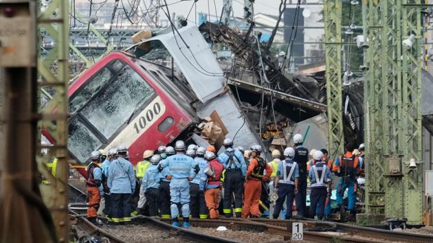 A train is seen derailed after a collision with a truck at a crossing in Yokohama, Kanagawa Prefecture. (Kazuhiro Nogi / AFP) 