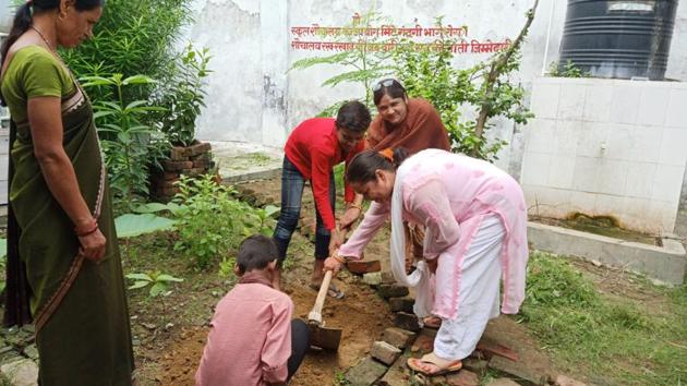 Teacher and children in a kitchen garden in government primary school, Rasulabad, in Prayagraj(HT)