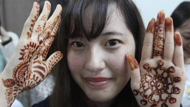 A student from Japan's Kyoto University shows her henna-painted hands, at Bedekar College, Thane, in Maharashtra. Students from the university are visiting as part of a cultural exchange program. (Praful Gangurde / HT Photo) A student from Japan's Kyoto University shows her henna-painted hands, at Bedekar College, Thane, in Maharashtra. Students from the university are visiting as part of a cultural exchange program. (Praful Gangurde / HT Photo)