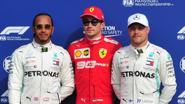 Ferrari's Charles Leclerc poses as he celebrates qualifying in pole position alongside second placed Mercedes' Lewis Hamilton and third placed Mercedes' Valtteri Bottas.(REUTERS)