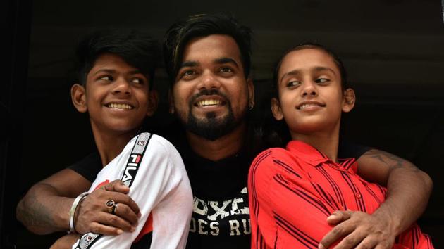 (L-R) Ali, 13, their dance instructor Shekhar Rao, 26 and Lovely, 12, in front of their Eternities Dance Academy at BNR colony, where the two train. Comaneci’s tweet shared a video Rao had put up of the two kids in school uniforms and bags in tow, somersaulting and cartwheeling down the street. “This is awesome,” Comaneci had tweeted on August 30, shooting the kids to viral fame. (Samir Jana / HT Photo) (L-R) Ali, 13, their dance instructor Shekhar Rao, 26 and Lovely, 12, in front of their Eternities Dance Academy at BNR colony, where the two train. Comaneci’s tweet shared a video Rao had put up of the two kids in school uniforms and bags in tow, somersaulting and cartwheeling down the street. “This is awesome,” Comaneci had tweeted on August 30, shooting the kids to viral fame. (Samir Jana / HT Photo)
