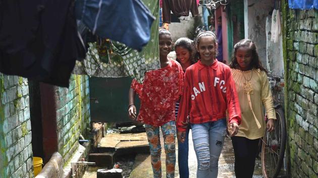 Jashika Khan aka Lovely (C) walks through the lanes of Hide Road Colony with friends. Appreciation followed from all quarters. Sports minister Kiren Rijiju also appreciated the video and a slew of interviews and appearances have come their way in the short span since. (Samir Jana / HT Photo) Jashika Khan aka Lovely (C) walks through the lanes of Hide Road Colony with friends. Appreciation followed from all quarters. Sports minister Kiren Rijiju also appreciated the video and a slew of interviews and appearances have come their way in the short span since. (Samir Jana / HT Photo)