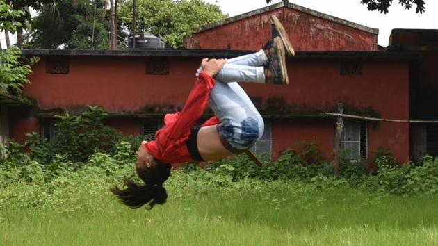 Lovely mid-somersault at a ground beside the Eternities Dance Academy at BNR colony. “I like doing gymnastics but dance has always been my passion,” Lovely said. (Samir Jana / HT Photo) Lovely mid-somersault at a ground beside the Eternities Dance Academy at BNR colony. “I like doing gymnastics but dance has always been my passion,” Lovely said. (Samir Jana / HT Photo)
