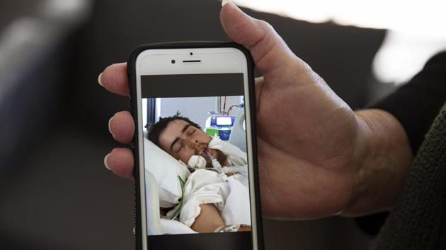 She never really intended to hurt either of them that day. But that little voice inside her urged her to do it; end the misery. The end also felt near one day in June, when doctors told Deb to say goodbye and placed Sam into a coma. Family and friends gathered. Day after day, she sat by his bed and prayed. She held up her phone to his face and played a song they both loved, “When the Rain Comes” by Third Day. (David Goldman / AP) She never really intended to hurt either of them that day. But that little voice inside her urged her to do it; end the misery. The end also felt near one day in June, when doctors told Deb to say goodbye and placed Sam into a coma. Family and friends gathered. Day after day, she sat by his bed and prayed. She held up her phone to his face and played a song they both loved, “When the Rain Comes” by Third Day. (David Goldman / AP)