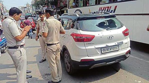 The bullet-riddled SUV in which the victim and his driver were travelling (HT Photo) The bullet-riddled SUV in which the victim and his driver were travelling (HT Photo)