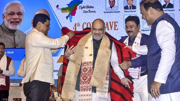 Union Home Minister Amit Shah being felicitated by Assam Chief Minister Sarbananda Sonowal during the 4th Conclave of the North East Democratic Alliance (NEDA) in Guwahati on Monday. (PTI PHOTO.) Union Home Minister Amit Shah being felicitated by Assam Chief Minister Sarbananda Sonowal during the 4th Conclave of the North East Democratic Alliance (NEDA) in Guwahati on Monday. (PTI PHOTO.)