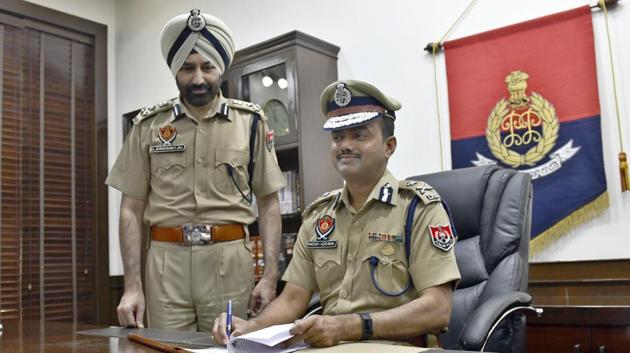 New Ludhiana police chief Rakesh Agarwal after joining his office on Tuesday. Seen standing next to him is his predecessor Sukhchain Singh Gill.(Gurpreet Singh/HT)