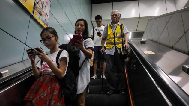 Grandpa Wong (R), rides an escalator in an MTR station. “We’re old now, but the children are the future of Hong Kong.” The three months of huge, sometimes violent pro-democracy protests in the semi-autonomous city are overwhelmingly youth-led. Research by academics has shown that half of those on the streets are between 20 and 30 years old, while 77% have degrees. (Vivek Prakash / AFP) Grandpa Wong (R), rides an escalator in an MTR station. “We’re old now, but the children are the future of Hong Kong.” The three months of huge, sometimes violent pro-democracy protests in the semi-autonomous city are overwhelmingly youth-led. Research by academics has shown that half of those on the streets are between 20 and 30 years old, while 77% have degrees. (Vivek Prakash / AFP)