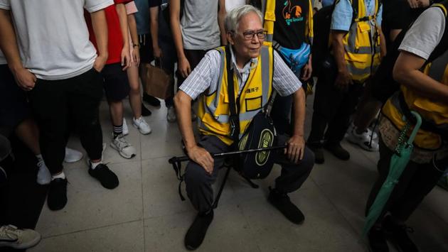 Grandpa Wong rests on a portable stool between protesters. Wong says he understands why youngsters feel they have no choice. He has watched over the decades as mainland China has grown more wealthy and powerful whilst remaining avowedly authoritarian. “If the Chinese Communist Party comes to Hong Kong, Hong Kong will become Guangzhou,” he sighed. “The authorities can lock you up whenever they want.” (Vivek Prakash / AFP) Grandpa Wong rests on a portable stool between protesters. Wong says he understands why youngsters feel they have no choice. He has watched over the decades as mainland China has grown more wealthy and powerful whilst remaining avowedly authoritarian. “If the Chinese Communist Party comes to Hong Kong, Hong Kong will become Guangzhou,” he sighed. “The authorities can lock you up whenever they want.” (Vivek Prakash / AFP)
