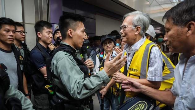 Grandpa Wong talks to a riot police officer. As Hong Kong’s summer of rage has worn on, violence on both sides has only escalated. Each weekend has brought increasingly violent bouts, with a minority of black-clad protesters using molotovs, slingshots and bricks. Police have also upped their violence, deploying water cannons and resorting to tear gas and rubber bullets. (Vivek Prakash / AFP) Grandpa Wong talks to a riot police officer. As Hong Kong’s summer of rage has worn on, violence on both sides has only escalated. Each weekend has brought increasingly violent bouts, with a minority of black-clad protesters using molotovs, slingshots and bricks. Police have also upped their violence, deploying water cannons and resorting to tear gas and rubber bullets. (Vivek Prakash / AFP)