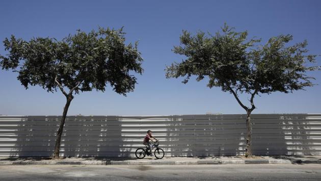 A boy rides his bicycle in Beitar Illit. Its densely built apartment blocs and Dollar stores seem a world apart from Havat Gilad’s huts and dirt roads. And unlike in Zar, residents cite financial concerns for moving here. (Nir Elias / REUTERS) A boy rides his bicycle in Beitar Illit. Its densely built apartment blocs and Dollar stores seem a world apart from Havat Gilad’s huts and dirt roads. And unlike in Zar, residents cite financial concerns for moving here. (Nir Elias / REUTERS)