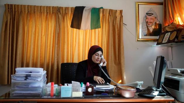 Bothena Turabe, 47, speaks on the phone as she works from her home in the village of Sarra near Havat Gilad. Turabe, saw the settlement’s growth from her Palestinian village Sarra, across the way. “In the night you look at them and you think there is nothing, and the next morning you look and you see there are more caravans,” said Turabe, a member of the village council. “This land is not yours to take - you're stealing it.” (Raneen Sawafta / REUTERS) Bothena Turabe, 47, speaks on the phone as she works from her home in the village of Sarra near Havat Gilad. Turabe, saw the settlement’s growth from her Palestinian village Sarra, across the way. “In the night you look at them and you think there is nothing, and the next morning you look and you see there are more caravans,” said Turabe, a member of the village council. “This land is not yours to take - you're stealing it.” (Raneen Sawafta / REUTERS)