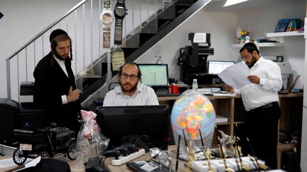 “We’re not here for ideological reasons,” said thirty-six year old David Hamburger, (C), a Beitar Illit shop owner. “There’s no way for us to buy houses anywhere else besides settlements.” With large families, seven children on average, high unemployment and poverty, the ultra-Orthodox Jews seek cheap housing that will allow their close-knit community to live together. (Nir Elias / REUTERS) “We’re not here for ideological reasons,” said thirty-six year old David Hamburger, (C), a Beitar Illit shop owner. “There’s no way for us to buy houses anywhere else besides settlements.” With large families, seven children on average, high unemployment and poverty, the ultra-Orthodox Jews seek cheap housing that will allow their close-knit community to live together. (Nir Elias / REUTERS)