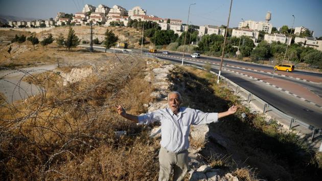 Ali Farun, 74, gestures by a road in al-Eizariya town with the Jewish settlement of Maale Adumim in the background. About 1.5 km from Maale Adumim, this resident of al-Eizariya has little hope of the territory ever coming under Palestinian control. “It doesn’t matter if they annex it to Jerusalem or if it remains West Bank - they control it man, one way or another,” said Farun. (Raneen Sawafta / REUTERS) Ali Farun, 74, gestures by a road in al-Eizariya town with the Jewish settlement of Maale Adumim in the background. About 1.5 km from Maale Adumim, this resident of al-Eizariya has little hope of the territory ever coming under Palestinian control. “It doesn’t matter if they annex it to Jerusalem or if it remains West Bank - they control it man, one way or another,” said Farun. (Raneen Sawafta / REUTERS)