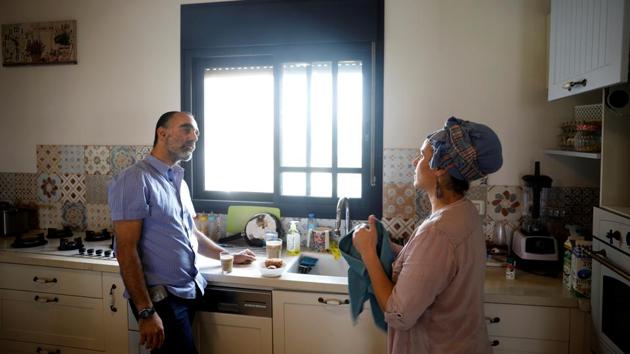 Itai Zar, 43 and Bat-Zion Zar, 41, founders of the Havat Gilad settlement chat in the kitchen of their home. “This belongs to the people of Israel, there's no question about it.” said Zar, who founded Havat Gilad in 2002 after his brother was shot dead by Palestinian militants nearby. “Eighteen years ago we came here, one family, and today we have a flourishing community.” (Ronen Zvulun / REUTERS) Itai Zar, 43 and Bat-Zion Zar, 41, founders of the Havat Gilad settlement chat in the kitchen of their home. “This belongs to the people of Israel, there's no question about it.” said Zar, who founded Havat Gilad in 2002 after his brother was shot dead by Palestinian militants nearby. “Eighteen years ago we came here, one family, and today we have a flourishing community.” (Ronen Zvulun / REUTERS)