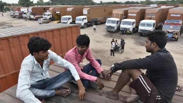 On the periphery of the village are massive parking lots for trailers that transport Maruti cars manufactured in the Gurugram plant. These days, hundreds of drivers sit idle awaiting ‘loading’ assignments. “Earlier, we used to do at least three assignments in a month. But for the past few months, we are lucky if we get even one trip,” said Gurmeet Singh, a driver. (Sanjeev Verma / HT Photo)