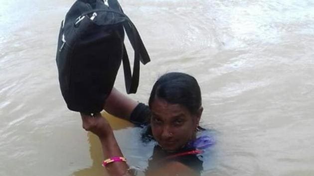 Teacher Binodini Samal risks her life everyday in the monsoons and wades through Sapua river in Dhenkanal district of Odisha to reach the primary school. (HT Photo) Teacher Binodini Samal risks her life everyday in the monsoons and wades through Sapua river in Dhenkanal district of Odisha to reach the primary school. (HT Photo)
