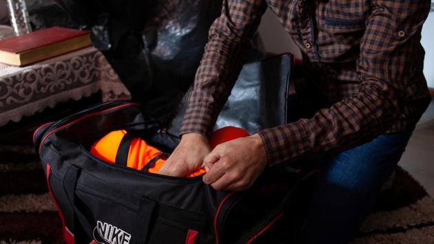 Ahmed packs life jackets for his family to travel to Greece. The family followed a Facebook group created by volunteers in Greece, posting about arriving boats, accidents and weather conditions. Every day, they heard and read stories of stormy waters causing accidents and of families drowning at sea because they didn’t have enough money to buy life jackets. (Ekaterina Anchevskaya / REUTERS) 