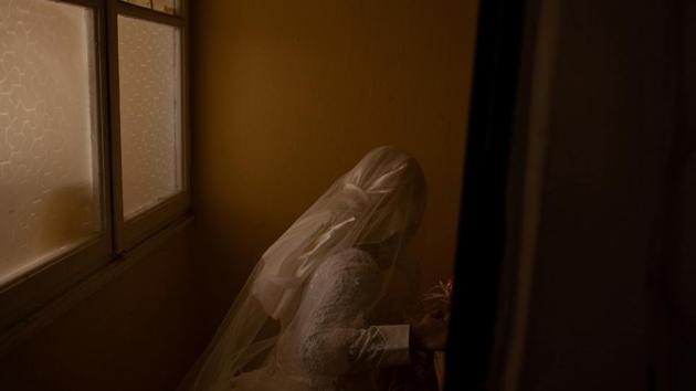 Hanin, 19, leaves her friend’s apartment in her wedding dress ready for her marriage to Ahmed in Izmir. Living in different cities, they exchanged text messages for months before Ahmed met her, which led to their engagement. Their engagement party was in Kilis, right across the border from war-torn Syria. (Ekaterina Anchevskaya / REUTERS) 