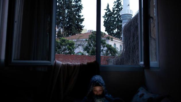 Hanin looks at her phone at her family’s apartment in Izmir. A year later, the family still wants to move to Europe but have written off the boat route. They don’t want to suffer the sting of humiliation again, insults in holding cells, the waste of limited funds. Ahmed said he would never go back to Syria because the situation has worsened, and because he would have to serve military service and fight for President Bashar al-Assad. (Ekaterina Anchevskaya / REUTERS) 