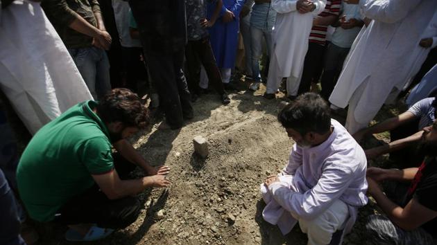 Relatives next to the grave of Asrar Khan in Srinagar. Last week Khan, 17, became the latest fatality when he died in hospital on September 3, a month after being seriously injured. Khan was playing cricket near his home on August 6 when soldiers fired at him, his mother told AFP. Senior army officer Lieutenant General Kanwal Jeet Singh Dhillon told reporters on September 4 that Khan was hit by protestors throwing stones. (Danish Ismail / REUTERS) 