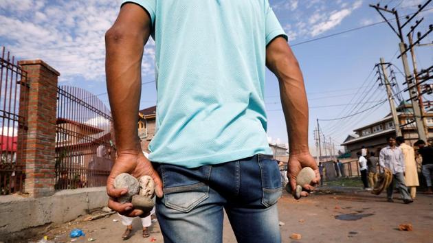 A Kashmiri man holds stones during clashes with security forces, in Srinagar on August 23. The same day as Malik’s statement, police said that a truck driver was killed on August 25 after being hit by a stone hurled by protestors. Internet and mobile phones also remain cut off in the valley. UN rights chief Michelle Bachelet said Monday she is “deeply concerned”. (Adnan Abidi / REUTERS) 