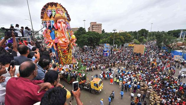 Devotees carry the 61ft tall Ganesha idol of Khairatabad pandal named ‘Dwadashaditya’ with 12 heads and 24 hands and adorned with 12 snakes for immersion in Hyderabad. More than 50,000 idols, majority of them in Hyderabad and outskirts, are being immersed in water bodies across Telangana. Most of Hyderabad’s idols are headed to the Husain Sagar Lake. (PTI) 