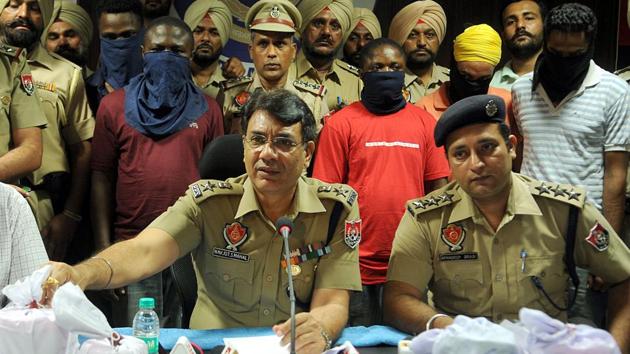 Police officials with arrested drugs peddlars in Jalandhar, last month. (Pardeep Pandit / HT Photo) Police officials with arrested drugs peddlars in Jalandhar, last month. (Pardeep Pandit / HT Photo)