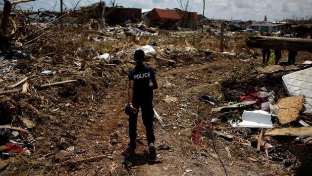 A police officer searches for the dead in a destroyed neighborhood after Hurricane Dorian hit the Abaco Islands in Marsh Harbour, Bahamas.(Reuters photo) A police officer searches for the dead in a destroyed neighborhood after Hurricane Dorian hit the Abaco Islands in Marsh Harbour, Bahamas.(Reuters photo)