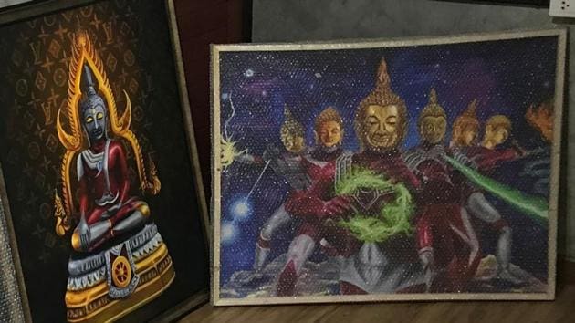 Paintings of Japanese superhero ‘Ultraman’ with Thai-style Buddha's head are seen in Bangkok.(REUTERS) Paintings of Japanese superhero ‘Ultraman’ with Thai-style Buddha's head are seen in Bangkok.(REUTERS)