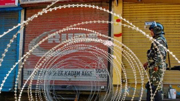 A security person stands guard at a blocked road during restrictions, after the abrogration of Article of 370 and bifurcation of state, Srinagar, September 9, 2019 (PTI) A security person stands guard at a blocked road during restrictions, after the abrogration of Article of 370 and bifurcation of state, Srinagar, September 9, 2019 (PTI)