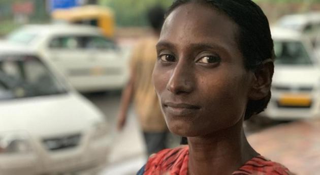 Sakeena, a resident of Central Delhi’s Sarai Kale Khan, works as an unofficial parking attendant alongside a busy avenue. (HT Photo) Sakeena, a resident of Central Delhi’s Sarai Kale Khan, works as an unofficial parking attendant alongside a busy avenue. (HT Photo)